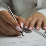 Businesswoman-Writing-in-notebook-Dubsado-Specialist
