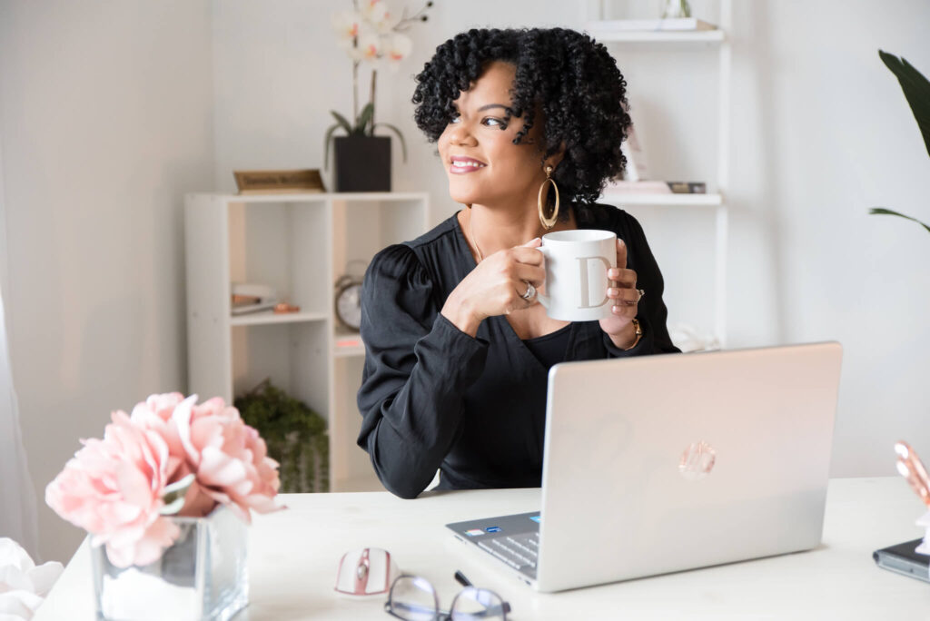 Danielle McGinnis, former Virtual Assistant, sitting at laptop.