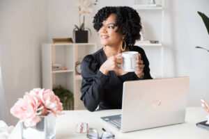 Danielle McGinnis, former Virtual Assistant, sitting at laptop.